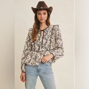 In February Black and Cream Floral Print Peplum Blouse & Ruffle Details Tie Neck